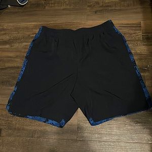 Dark blue and black Tapout athletic shorts. Large in Men’s with draw strings.